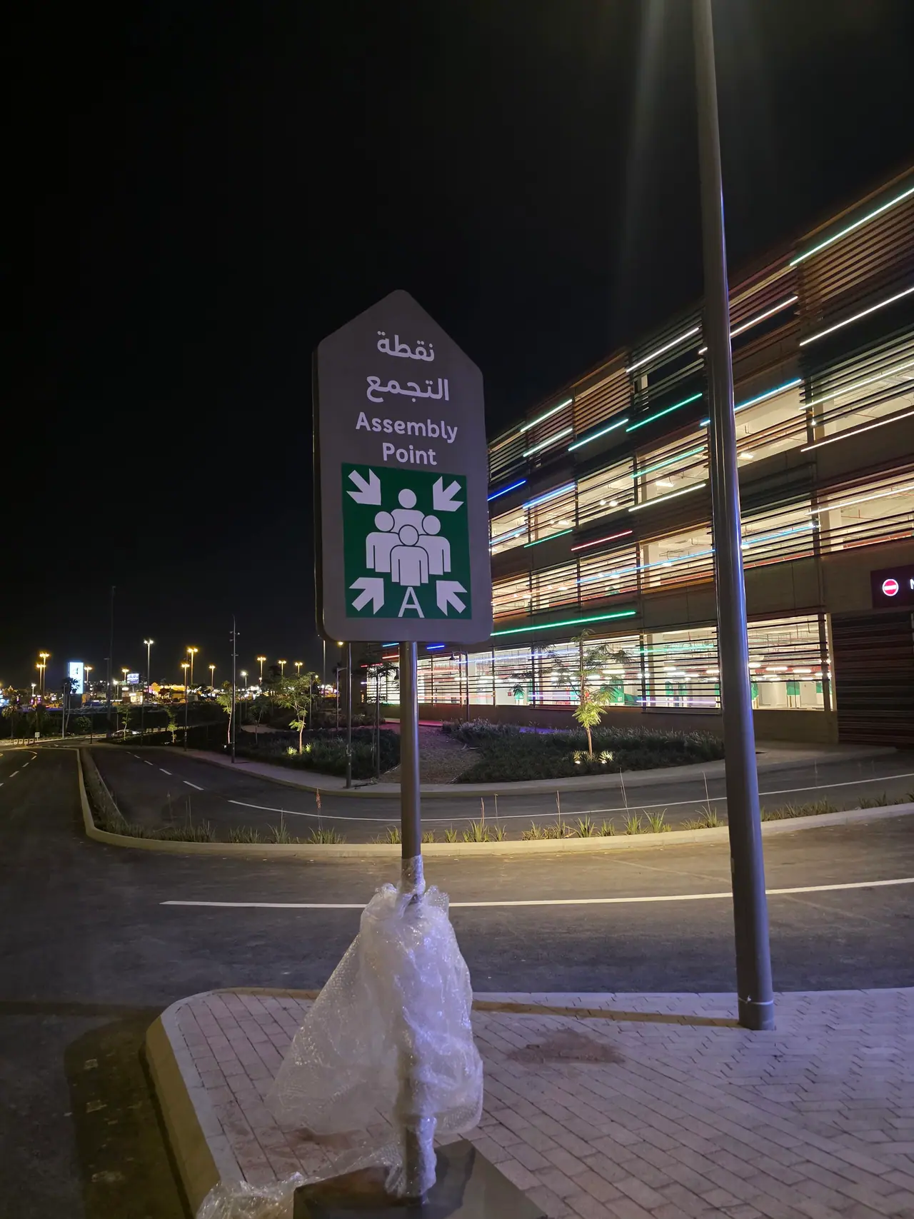 Seven Abha — Destination Graphics & Wayfinding — Assembly-point sign, installed and protected before handover