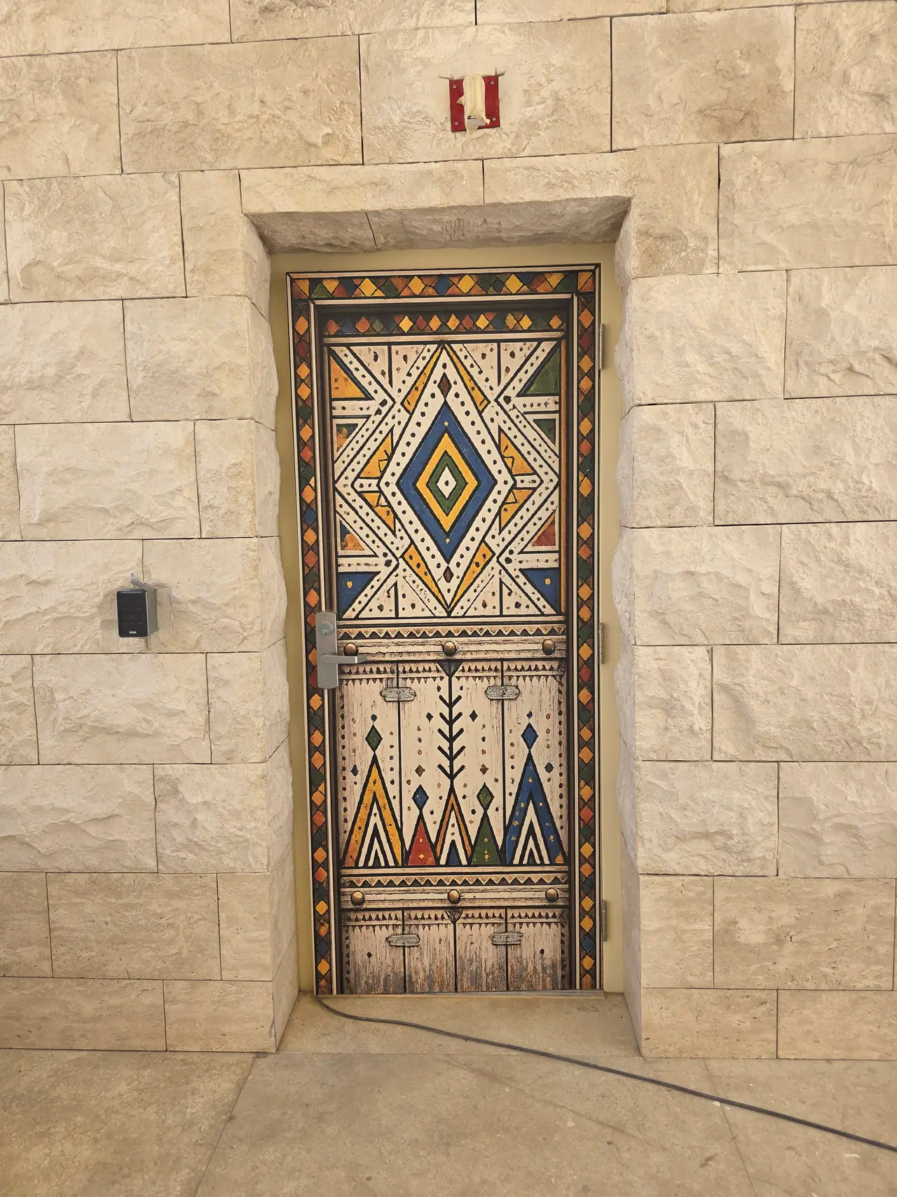 Seven Abha — Destination Graphics & Wayfinding — Asiri heritage pattern applied to a service door